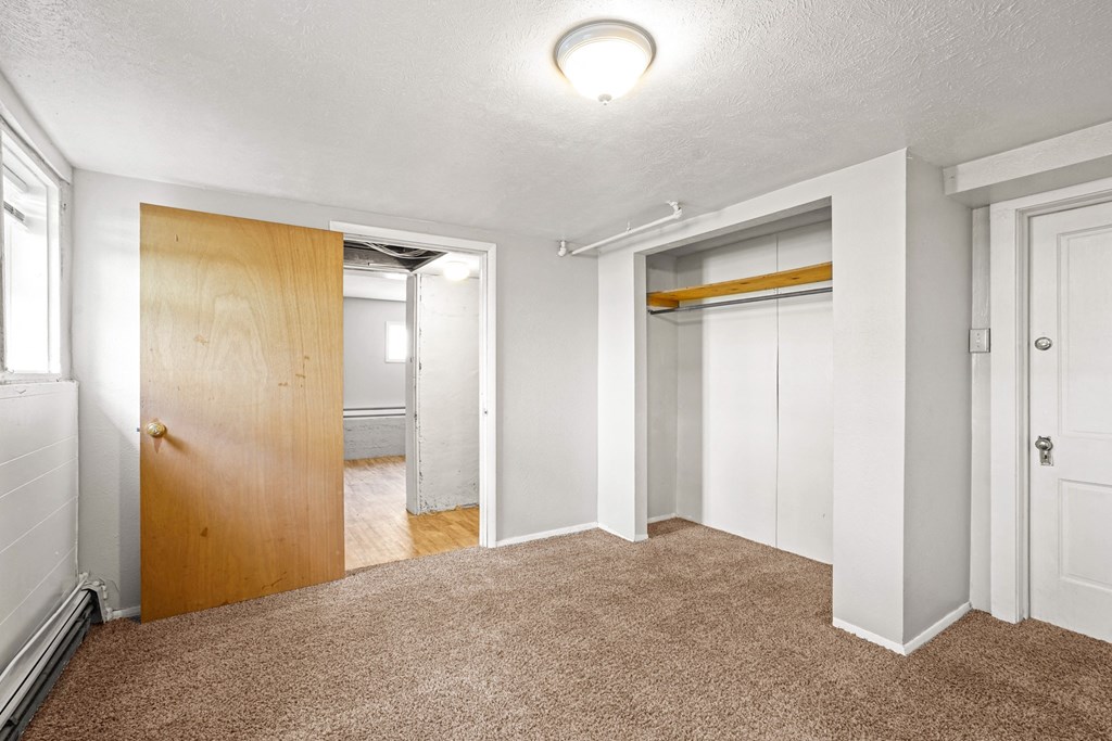A room with a carpeted floor and white walls.