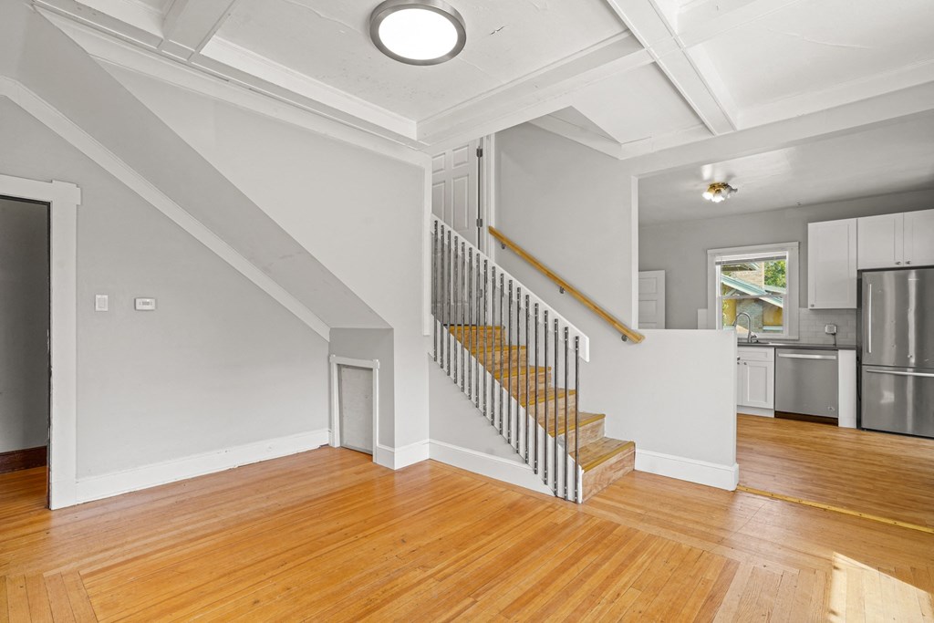 A white room with a staircase leading to a second floor.