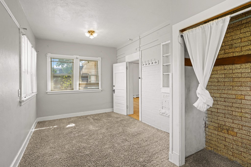 A room with a window and a door.