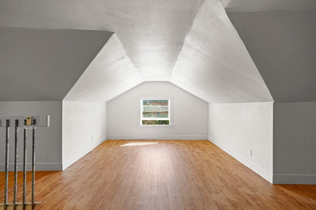 A room with wooden floors and white walls.