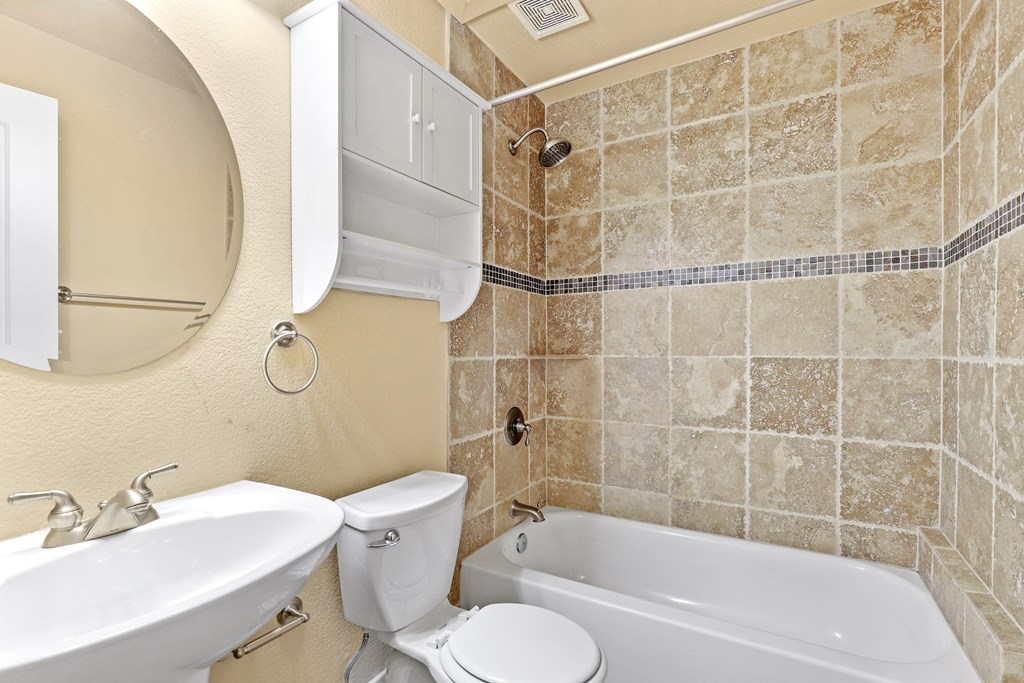 a bathroom with a toilet sink and bathtub