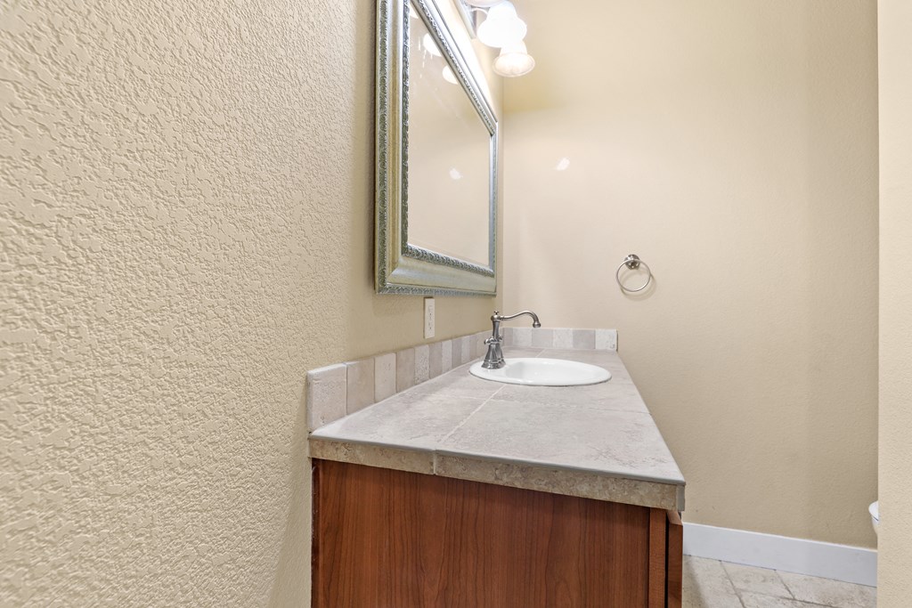 a bathroom with a sink and mirror