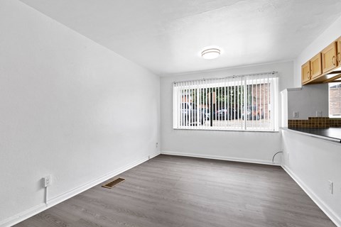 an empty living room with a large window