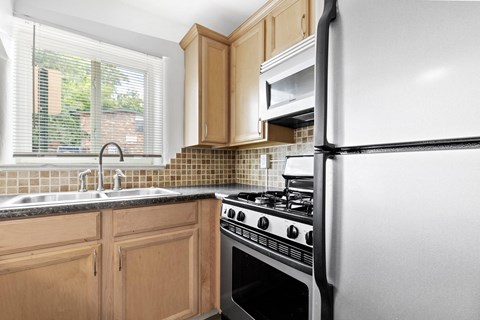 a kitchen with white appliances and wood cabinets