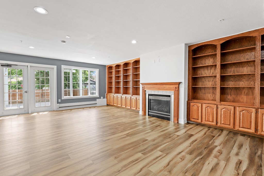 a living room with hardwood floors and a fireplace