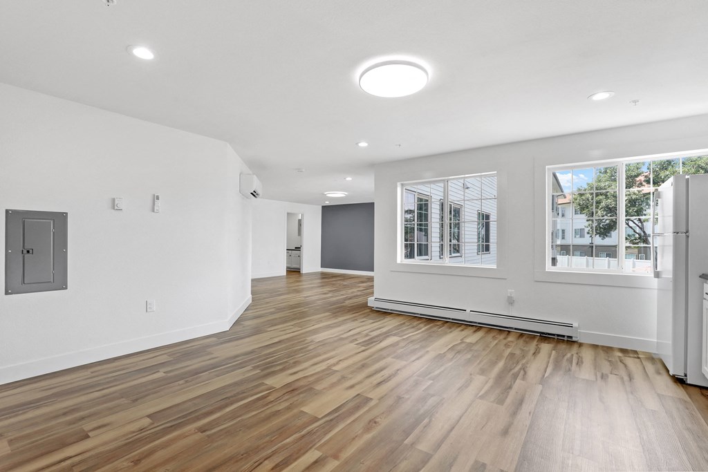 a living room with hardwood floors and white walls
