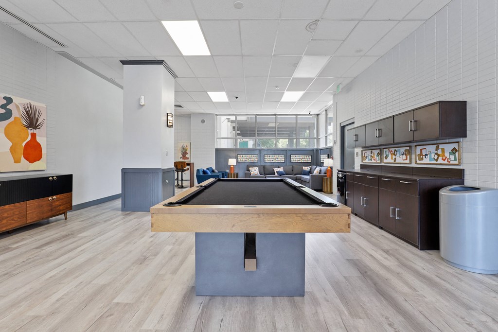 a room with a pool table in the middle of it