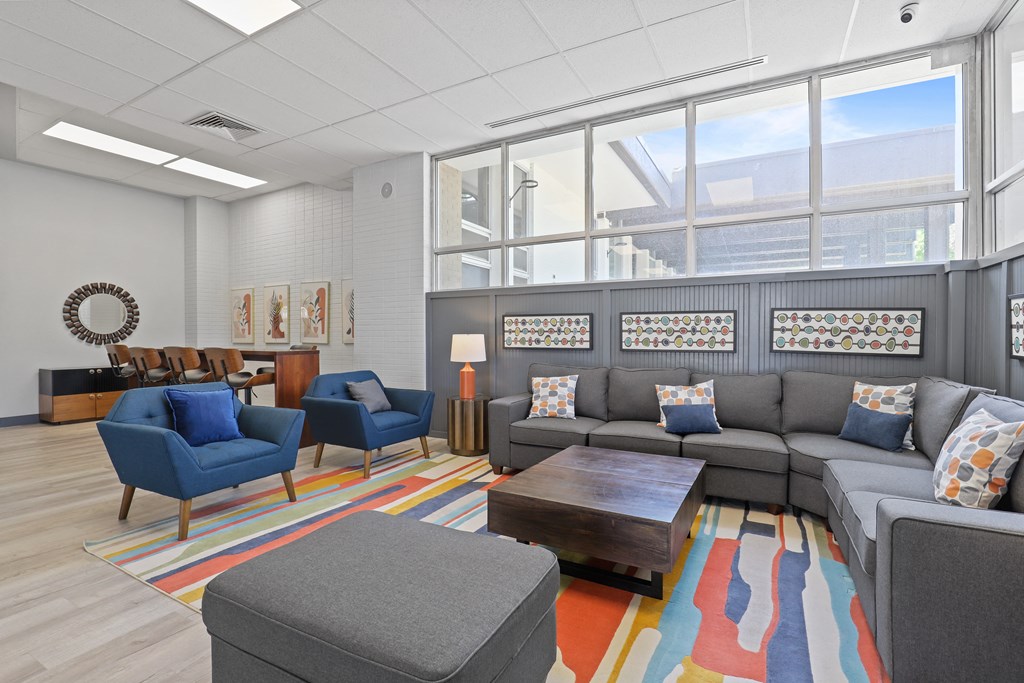a seating area with couches chairs and a coffee table