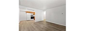 a bedroom with a medium hardwood floor and white walls