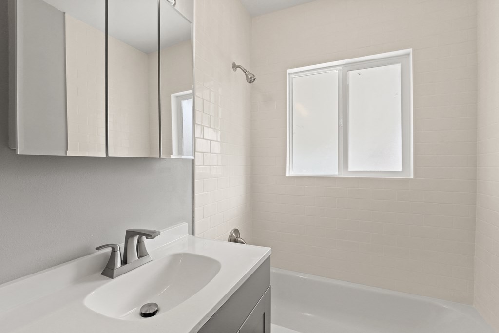 an empty bathroom with a sink and a bath tub