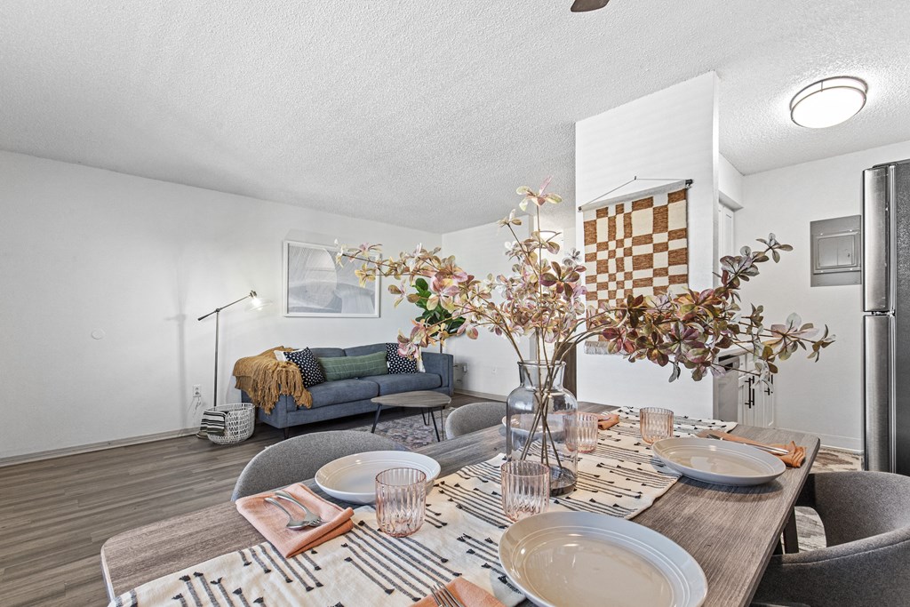 a living room with a dining table and a couch