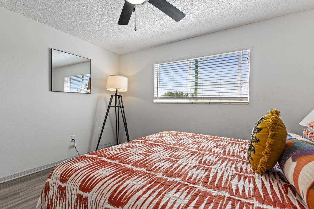 the master bedroom has a large bed and a large window