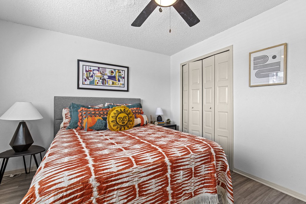 a bedroom with a bed and a ceiling fan