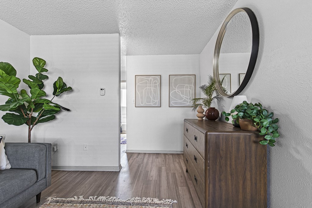 a living room with a dresser and a mirror