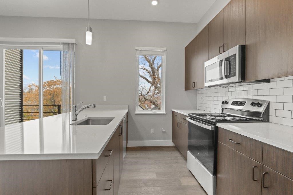 a kitchen with a sink and a stove and a window