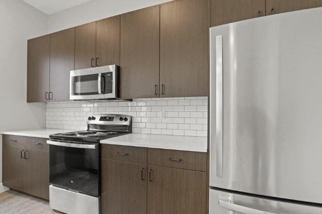 a kitchen with a stove and a refrigerator