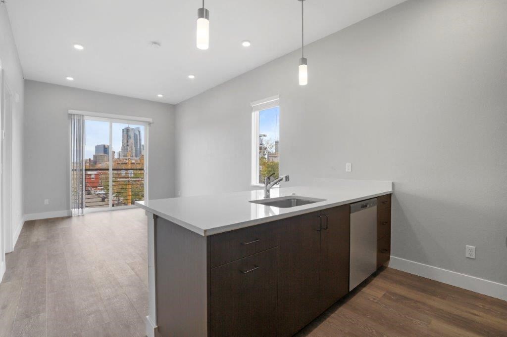 an empty kitchen with a sink and a window