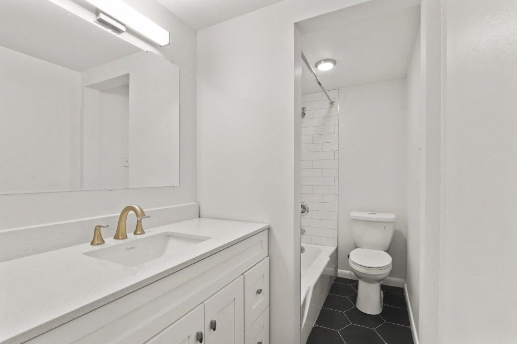 a bathroom with a sink and a toilet and a shower