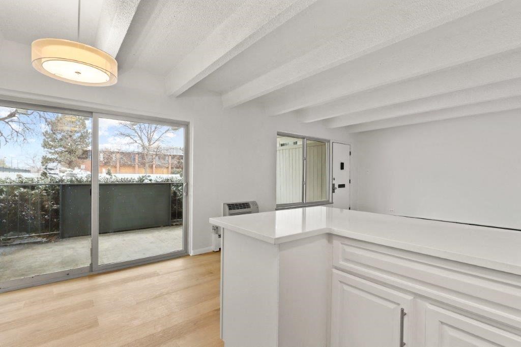 a kitchen with a counter top and a sliding glass door