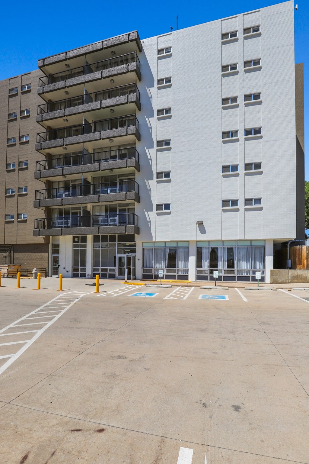 an empty parking lot in front of an apartment building