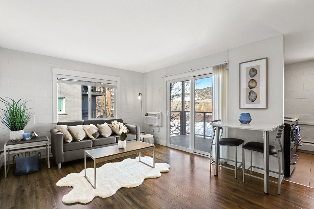 a living room with a couch and a table and sliding glass doors