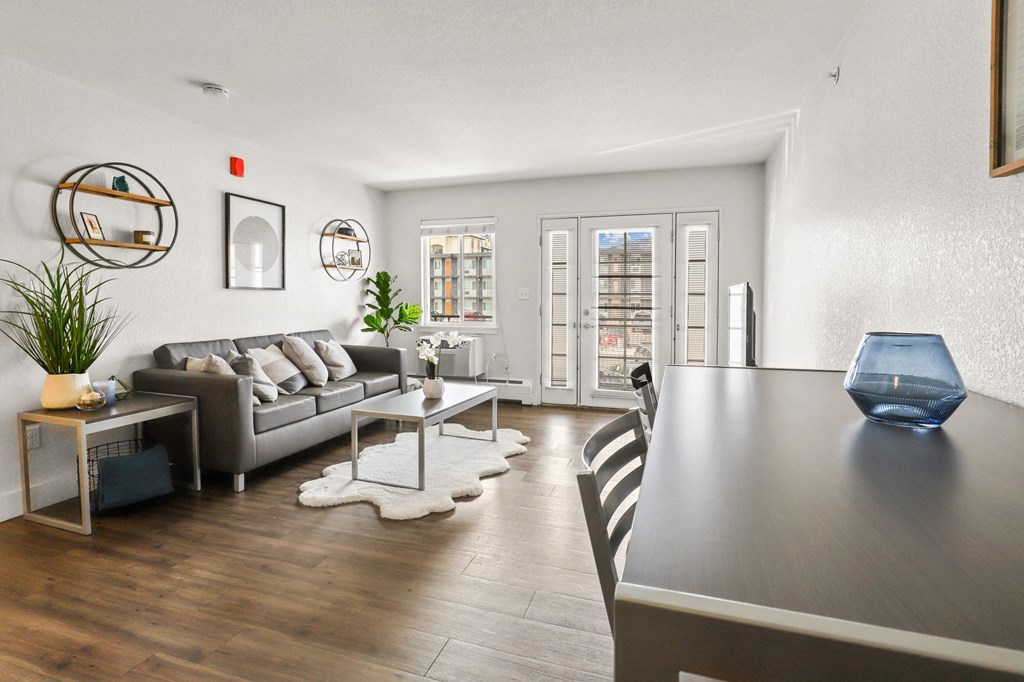 a living room with couches and a table and a dining room table