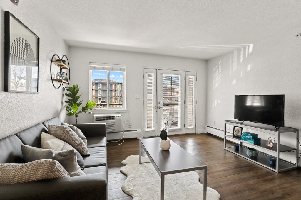 a living room with a leather couch and a tv