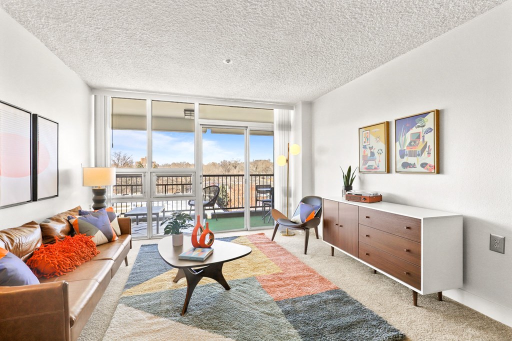 a living room with a large window and a couch