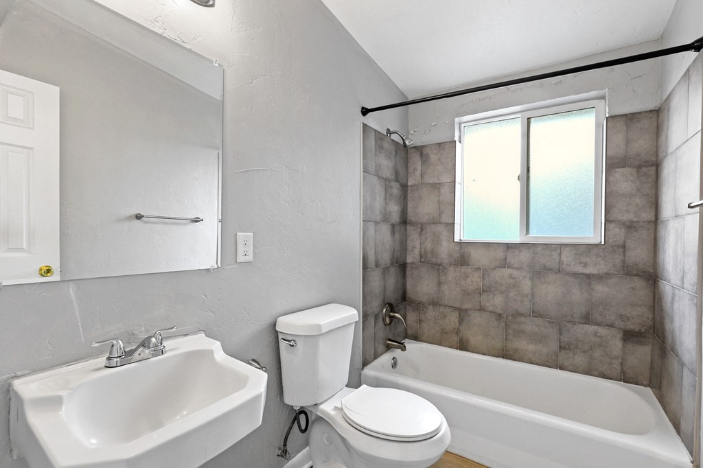 a bathroom with a sink toilet and bathtub