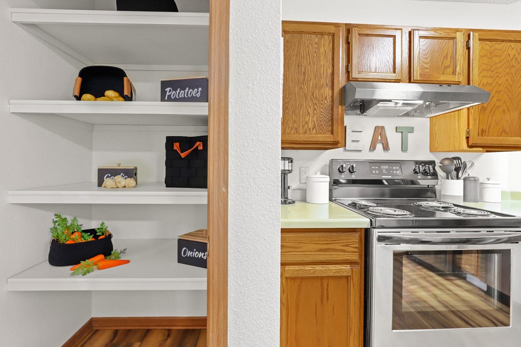 a kitchen with wooden cabinets and a stove and a refrigerator
