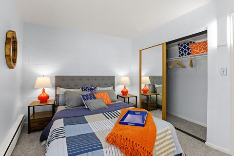 a bedroom with a large bed and a mirror