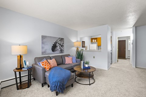 the living room of our apartments with a couch and a coffee table
