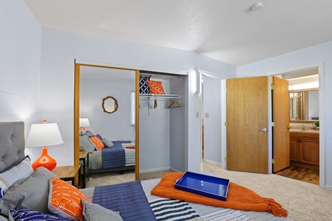 a living room with a couch and a bed with a tablet on it