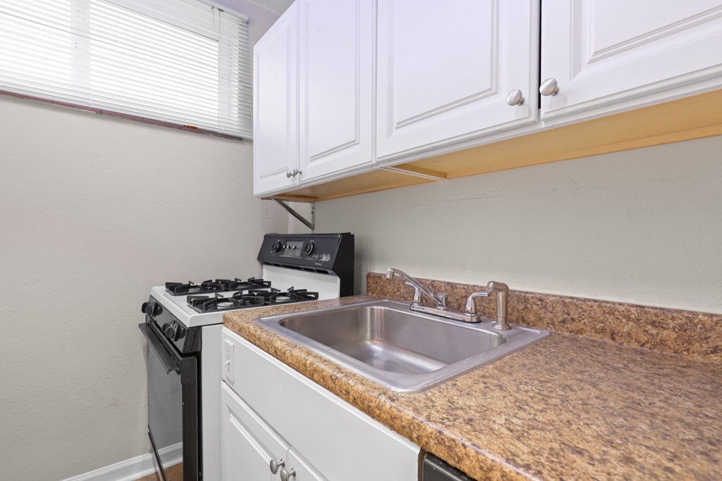 the kitchen of our studio apartment atrium with stove and sink