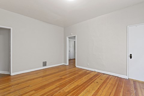 a living room with wood floors and white walls
