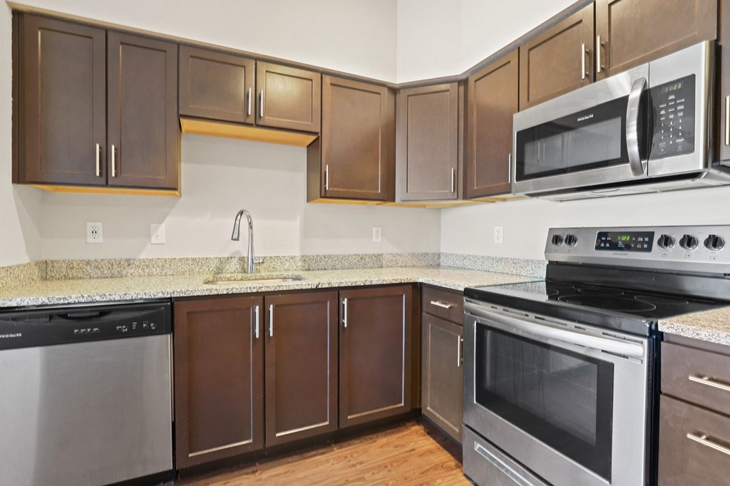 a kitchen with stainless steel appliances and granite counter tops