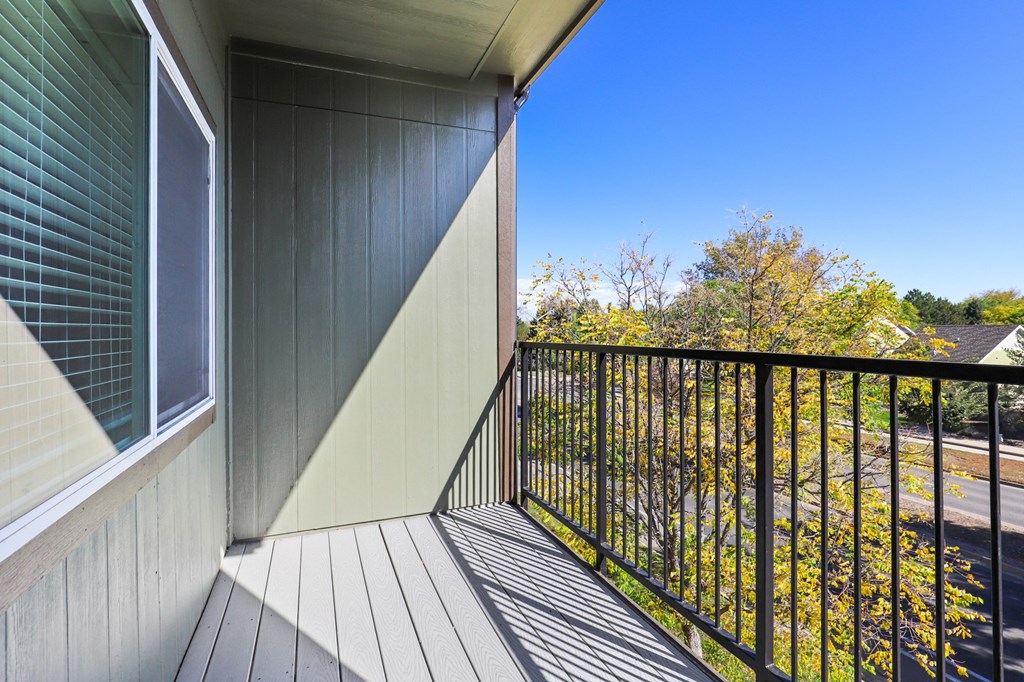 a balcony with a view of a yard and a house