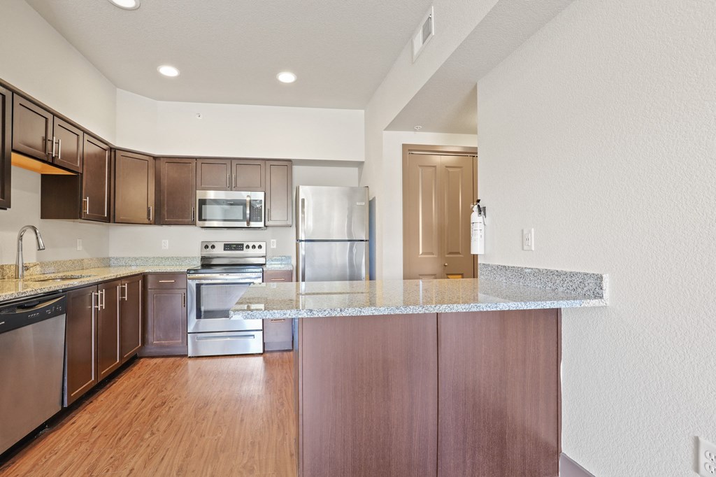 a kitchen with stainless steel appliances and granite counter tops