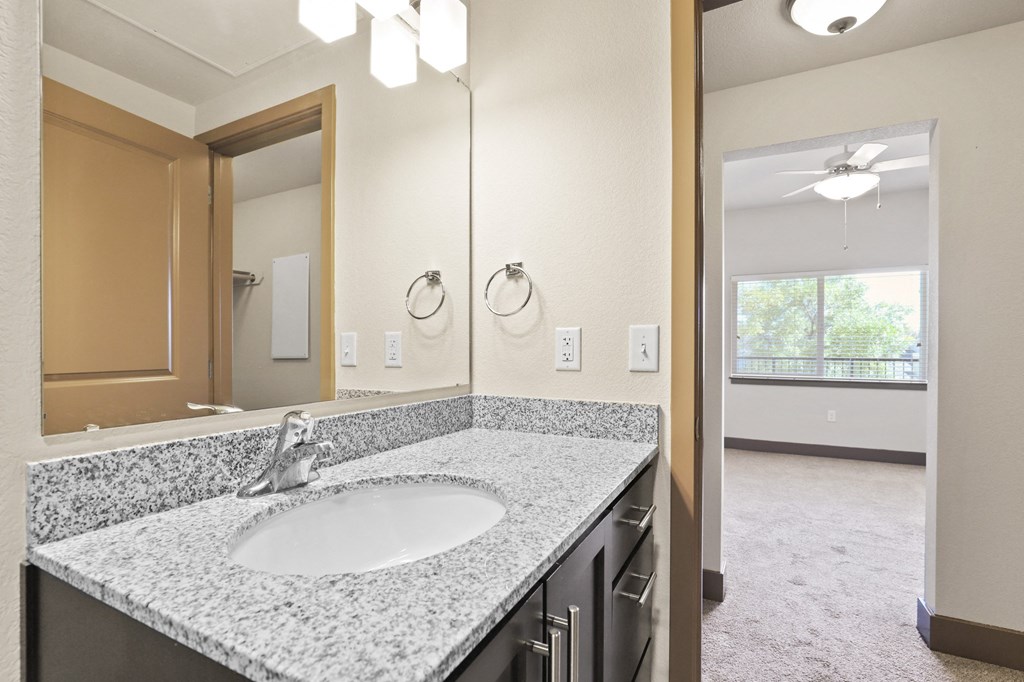 an empty bathroom with a sink and a mirror