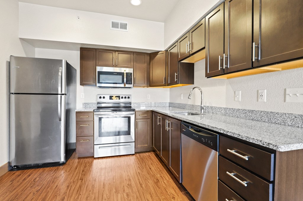 a kitchen with stainless steel appliances and granite counter tops and