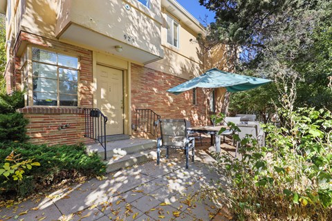 the front of a house with a patio and an umbrella