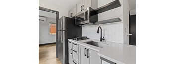 a kitchen with white cabinets and a white counter top