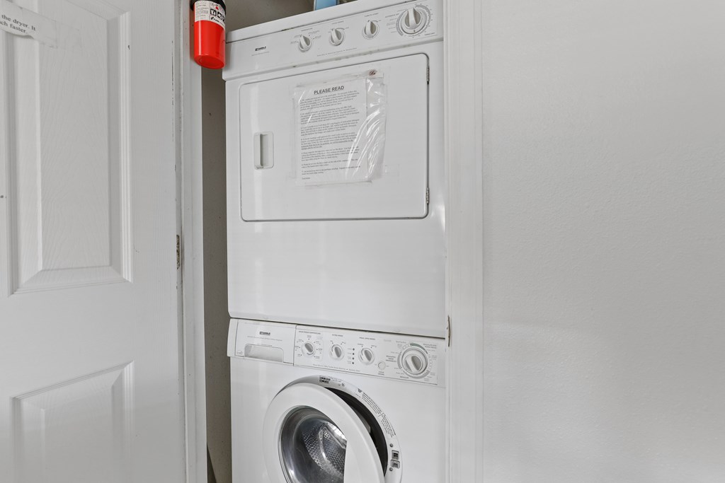 A white washing machine and dryer in a laundry room.