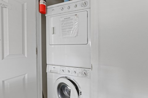 A white washing machine and dryer in a laundry room.