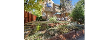 the front yard of a house with a patio and a garden