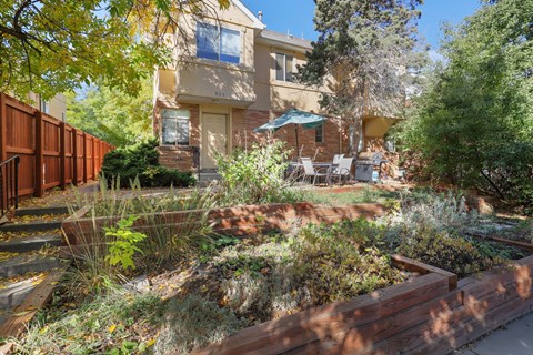the front yard of a house with a patio and a garden