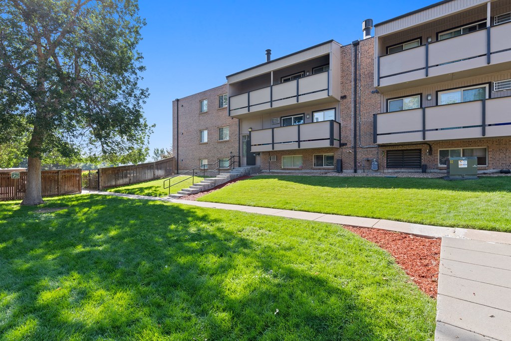Apartment building with a green lawn in front.