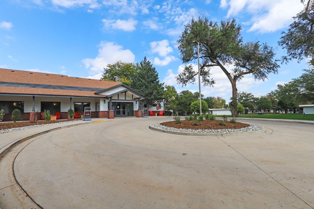 an empty parking lot with a building in the background