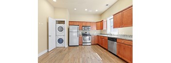 a kitchen with wood cabinets and stainless steel appliances