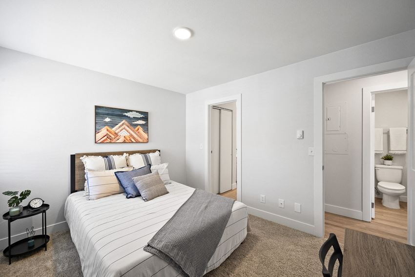 a bedroom with a bed and a bathroom with a toilet